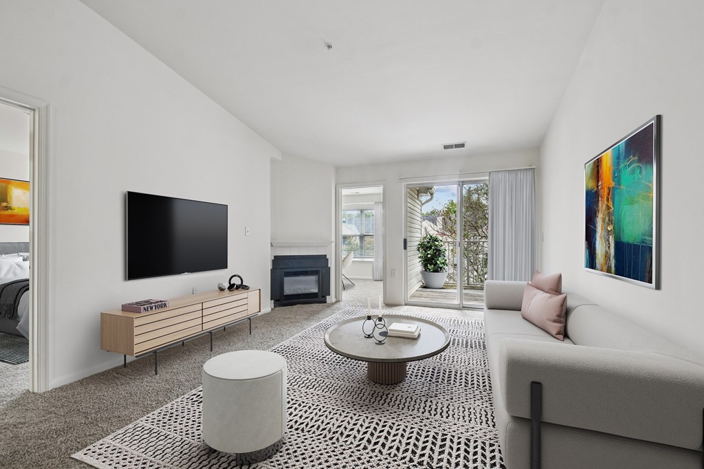 A modern living room with a television, sofa, and a coffee table.