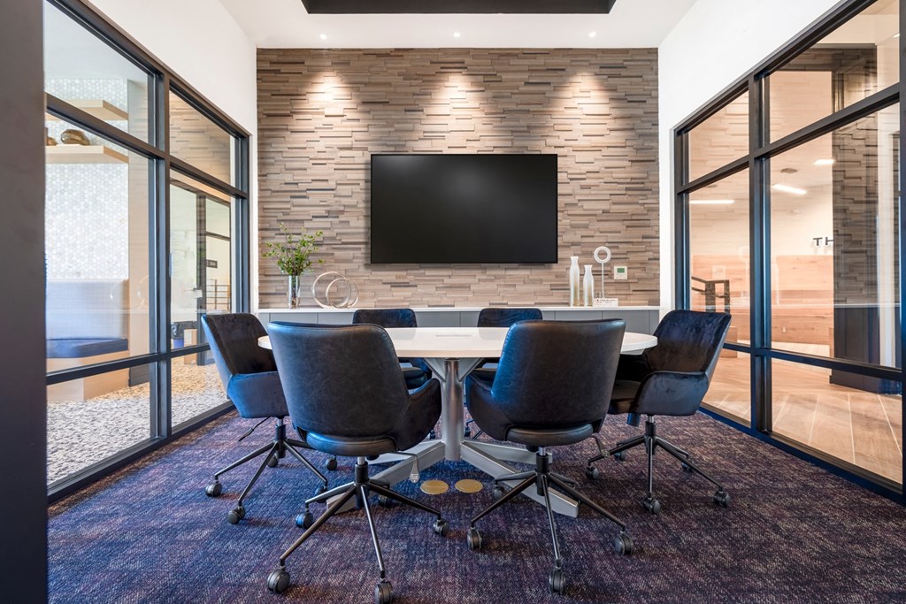 a conference room with a table and chairs