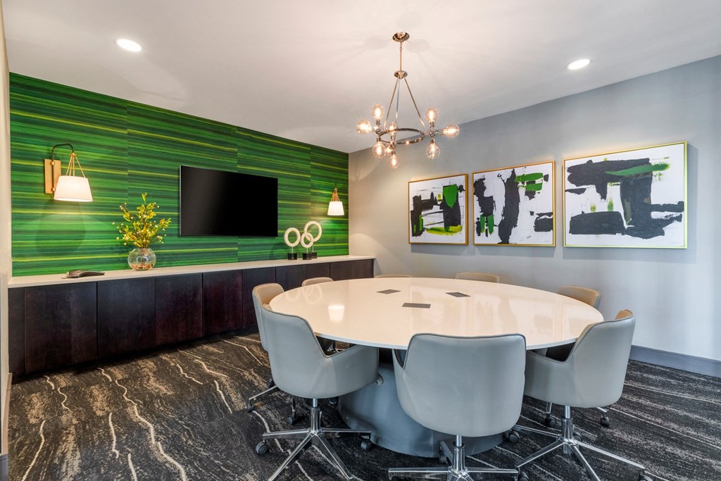 a conference room with a round table and chairs