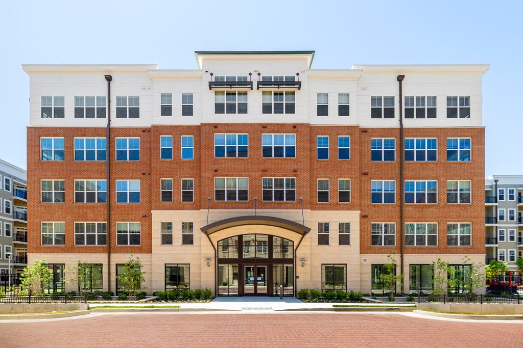 a large brick building with a white roof and blue windows