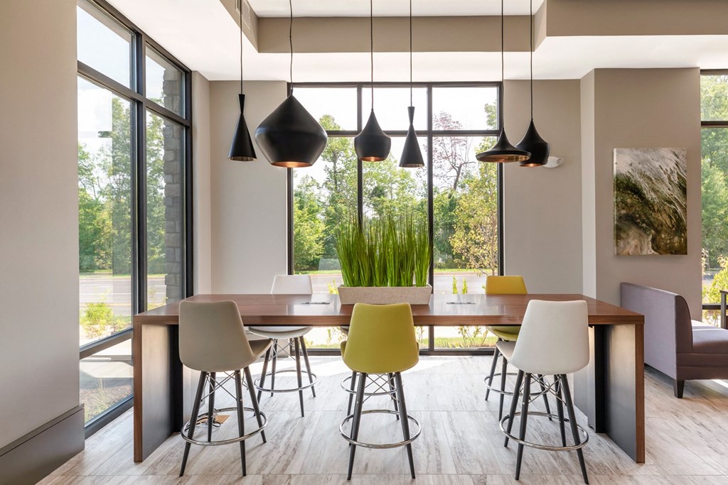 a modern dining room with a wooden table and chairs
