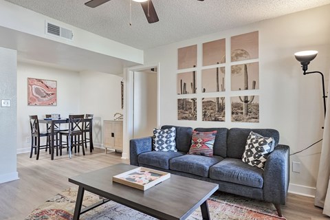 A living room with a grey couch and a coffee table.