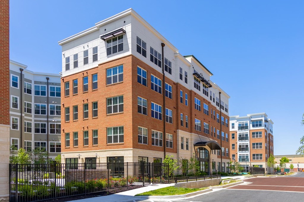 a large brick building with a black fence in front of it