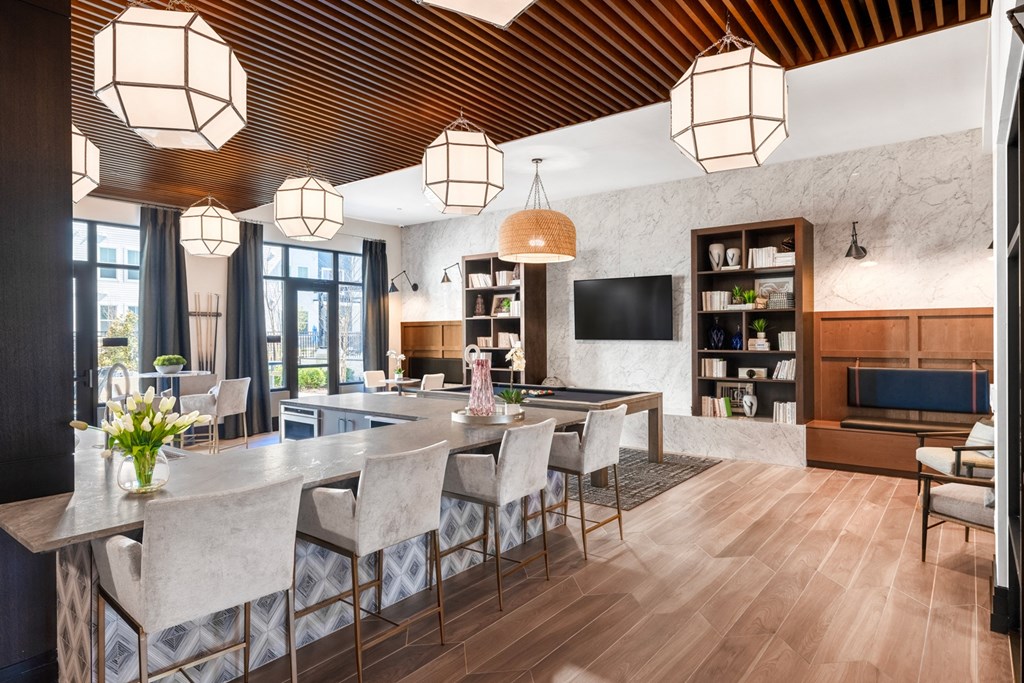 a living room with a dining room table and chairs and a kitchen