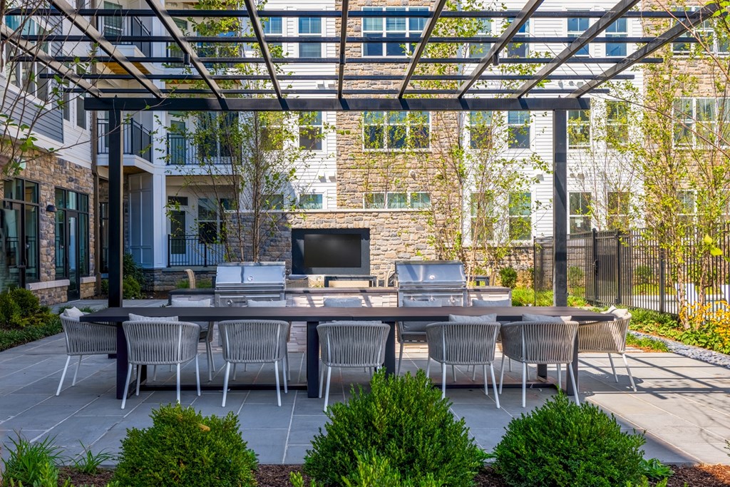 a patio with a table and chairs and a tv