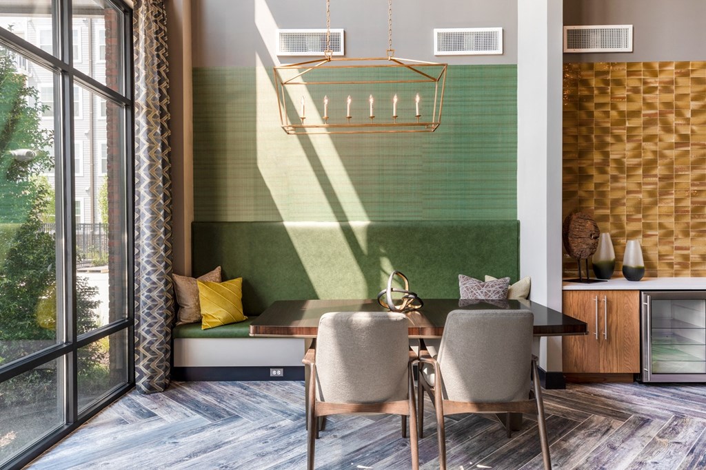 a living room with a table and chairs and a window