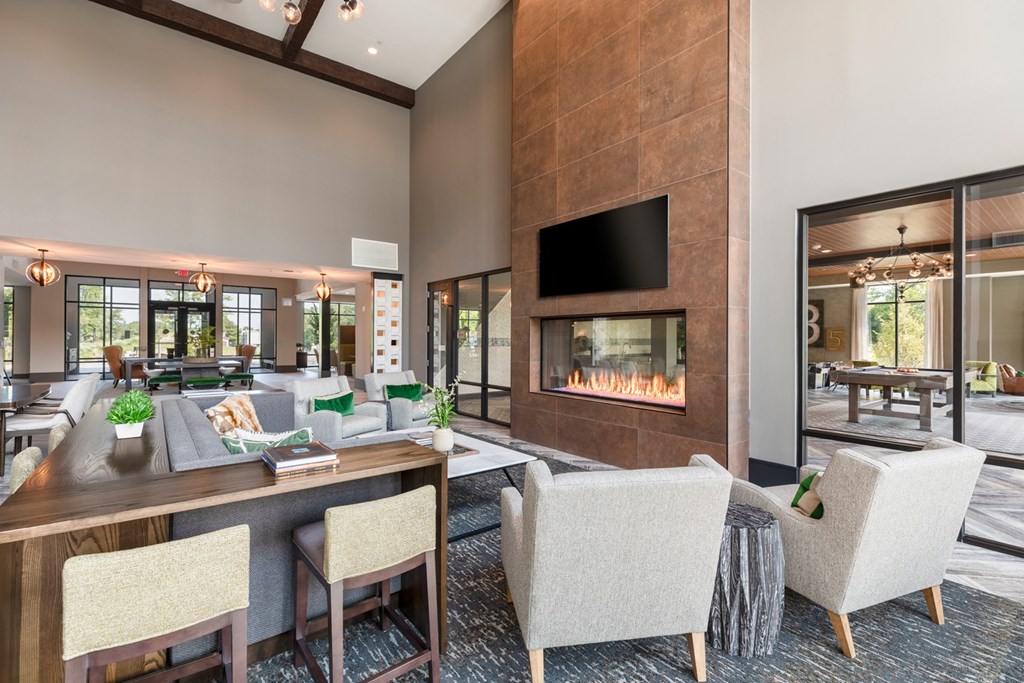 a living room filled with furniture and a large fireplace