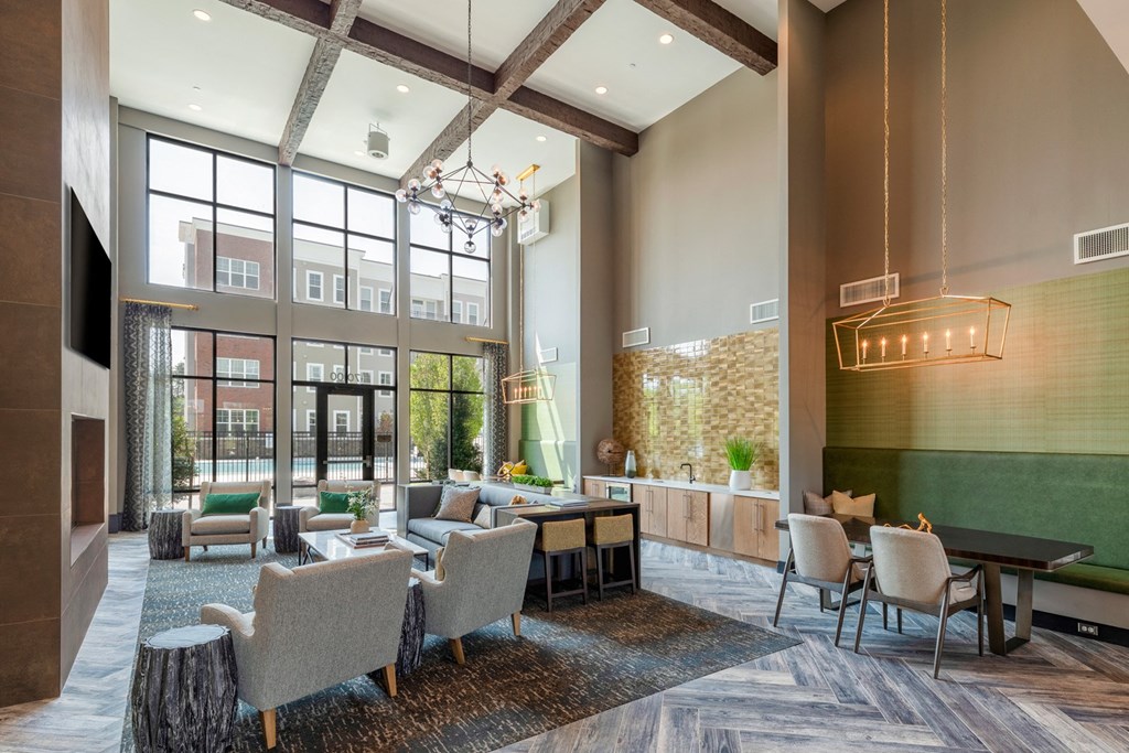 a large lobby with chairs and tables and large windows