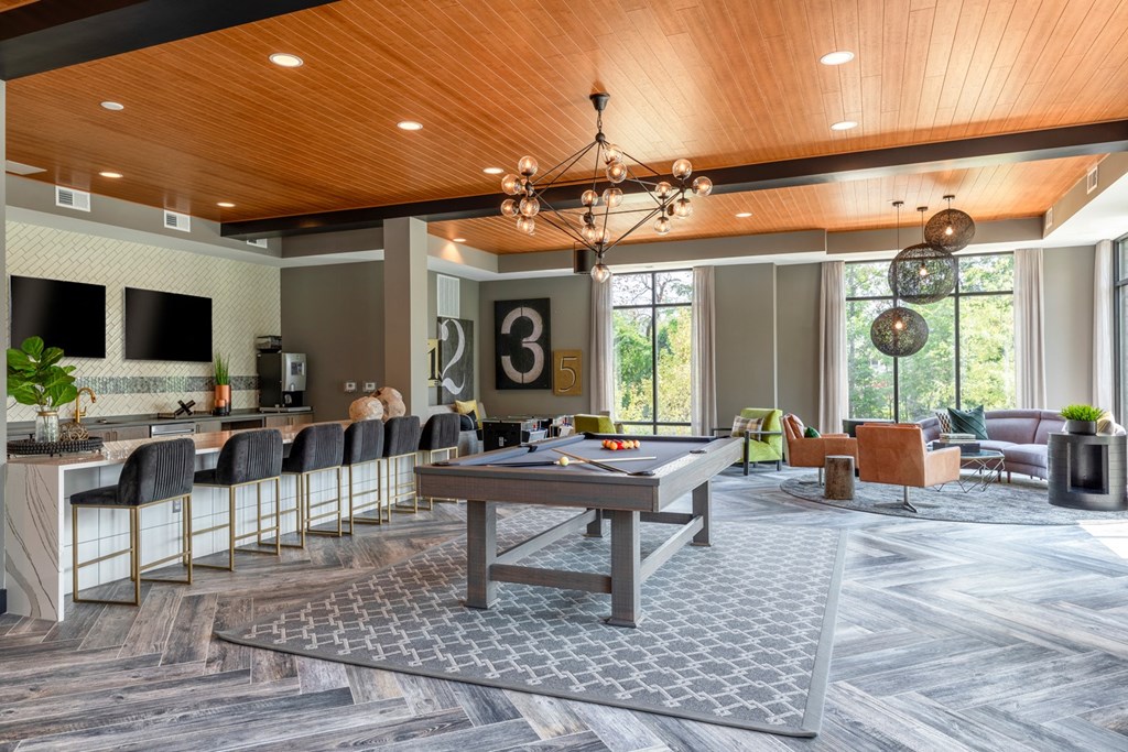 a gathering room with a pool table and a bar