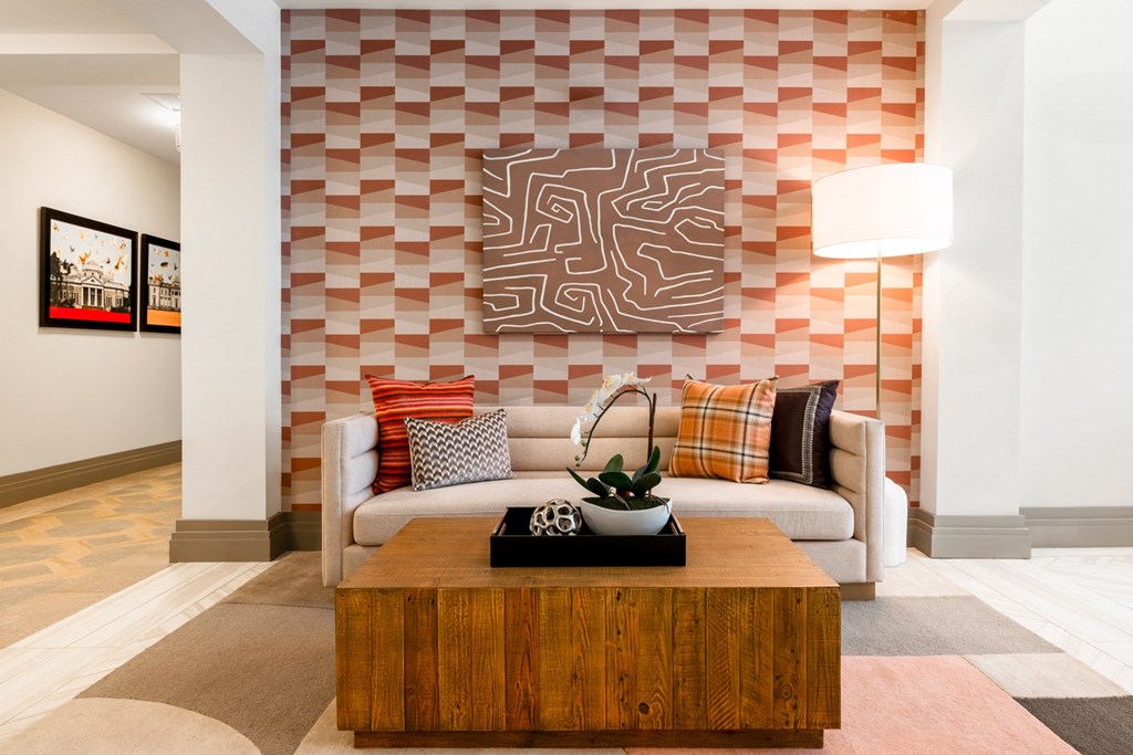 a living room with a white couch and a wooden coffee table