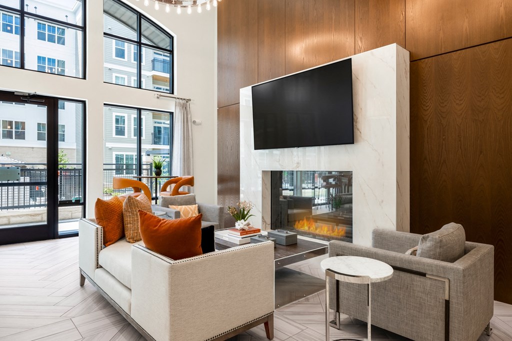 a living room with a fireplace and a flat screen tv above it