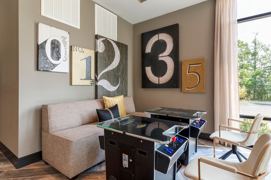 a living room with a foosball table and a couch