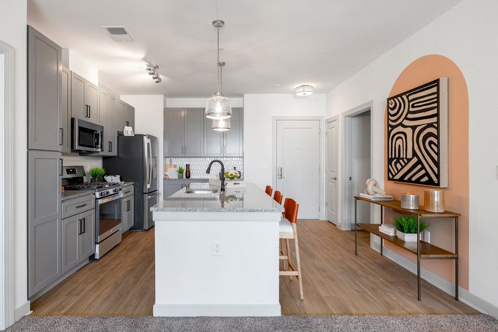 The Forge, an open kitchen and dining area with a large island and stainless steel appliances