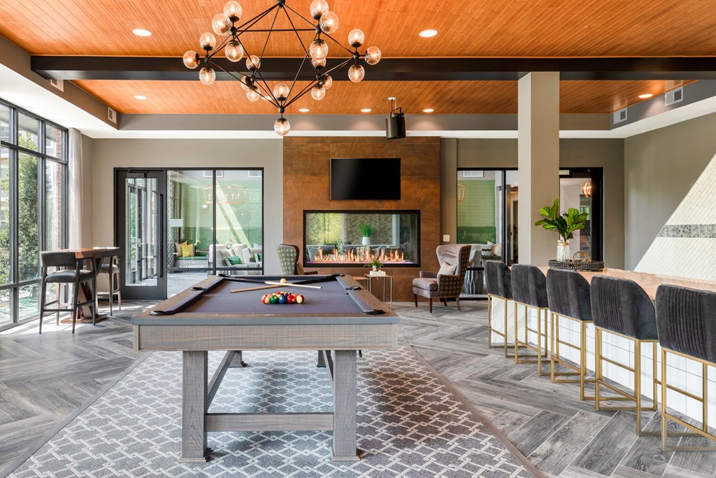 a large room with a pool table and a fireplace