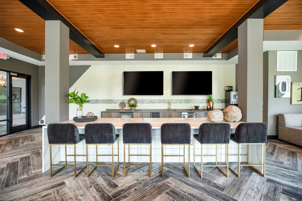 a large table with chairs in a room with a couch and a television in the background