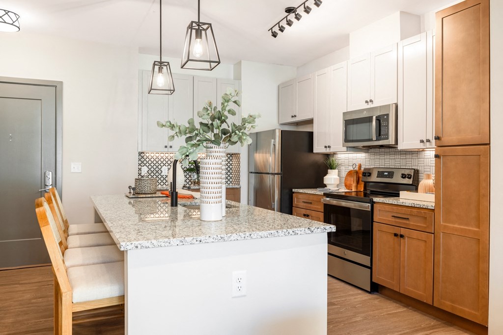 a kitchen with a large island with granite countertops