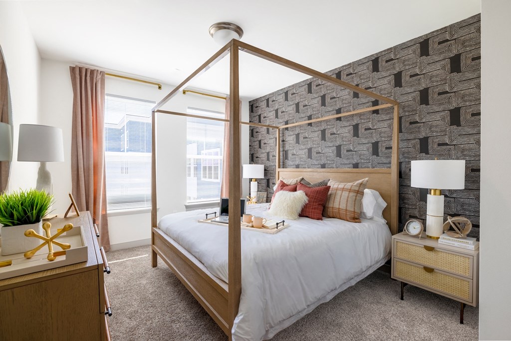 The Forge bedroom with a bed in front of a brick wall