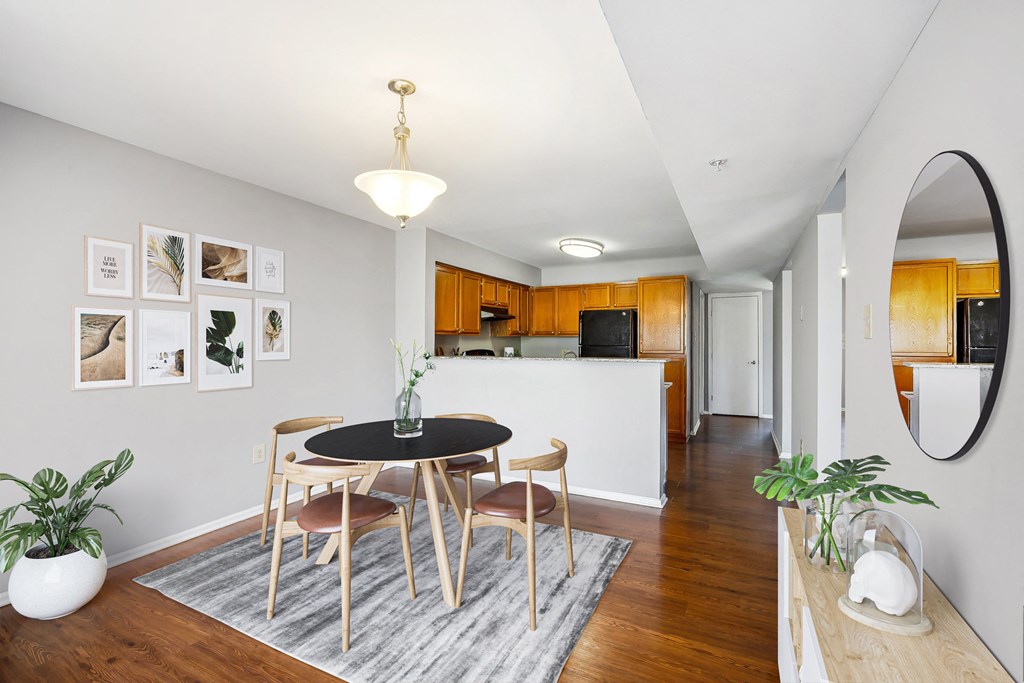 a dining room with a table and chairs and a kitchen at Villages at Morgan Metro, Maryland
