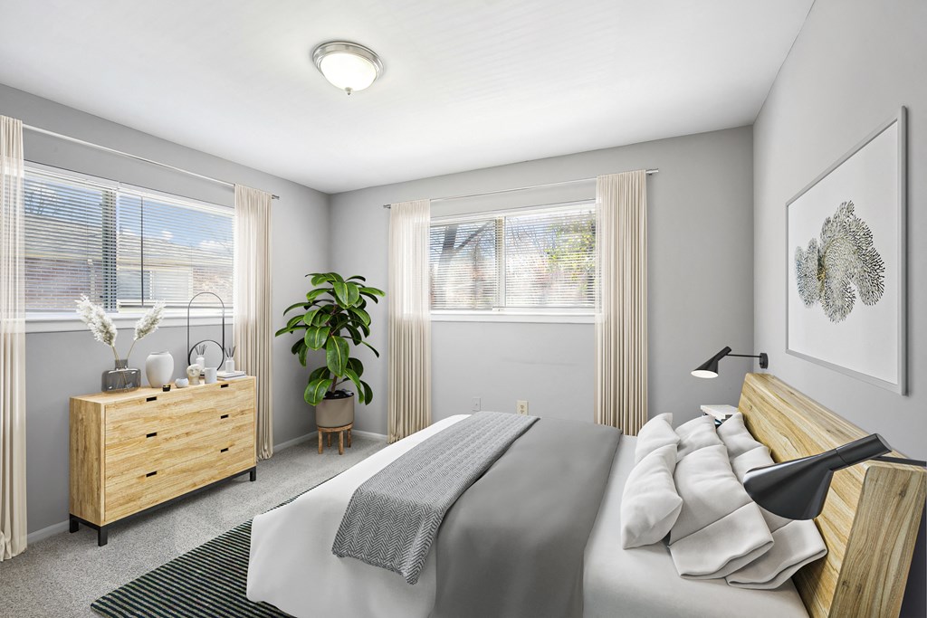 a bedroom with a bed and a dresser and two windows at Villages at Morgan Metro, Landover, 20785