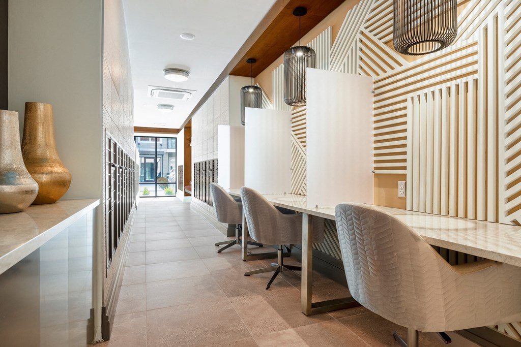 a long table with chairs and a counter with vases on it