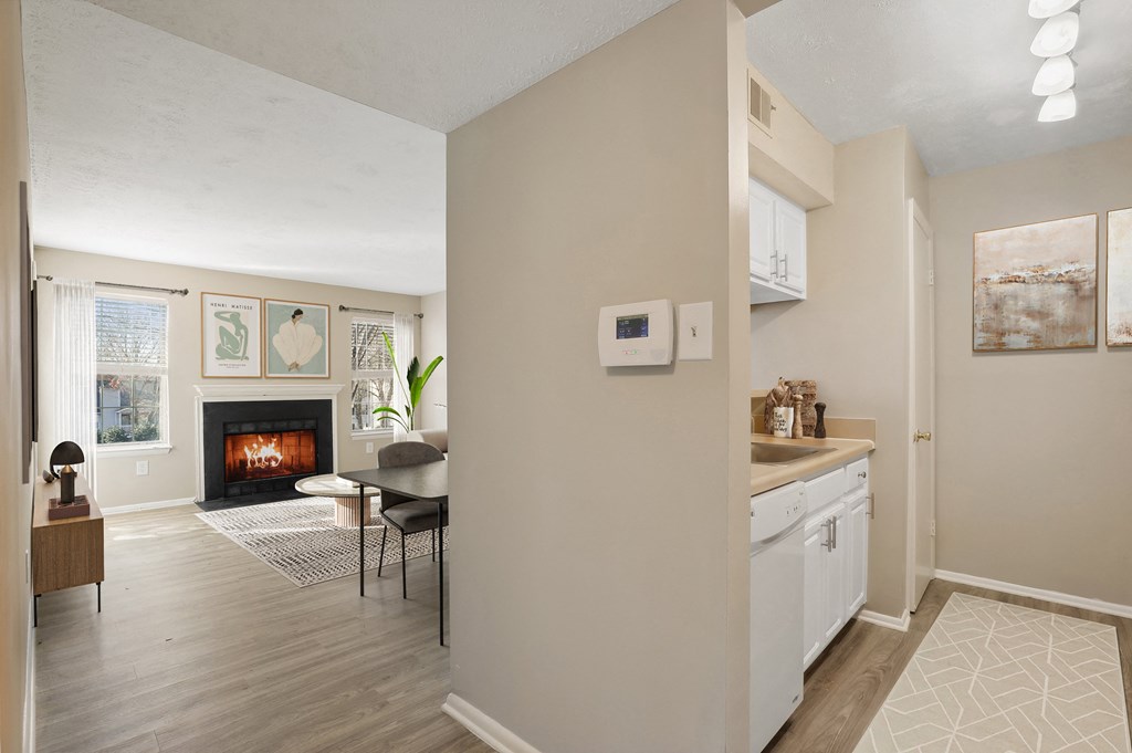 a living room and dining room with fireplace at Madison at Eden Brook, Columbia, 21046