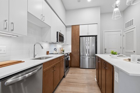 A modern kitchen with wooden cabinets and stainless steel appliances.