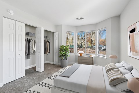 A bedroom with a large bed and a wardrobe at Poplar Glen Apartments, Columbia, MD, 21044.