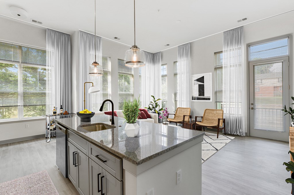 The Forge kitchen with a large island and a living room in the background