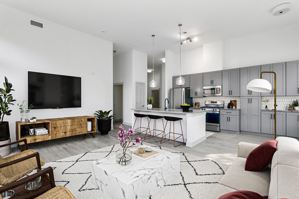 The Forge spacious living room with a kitchen in the background