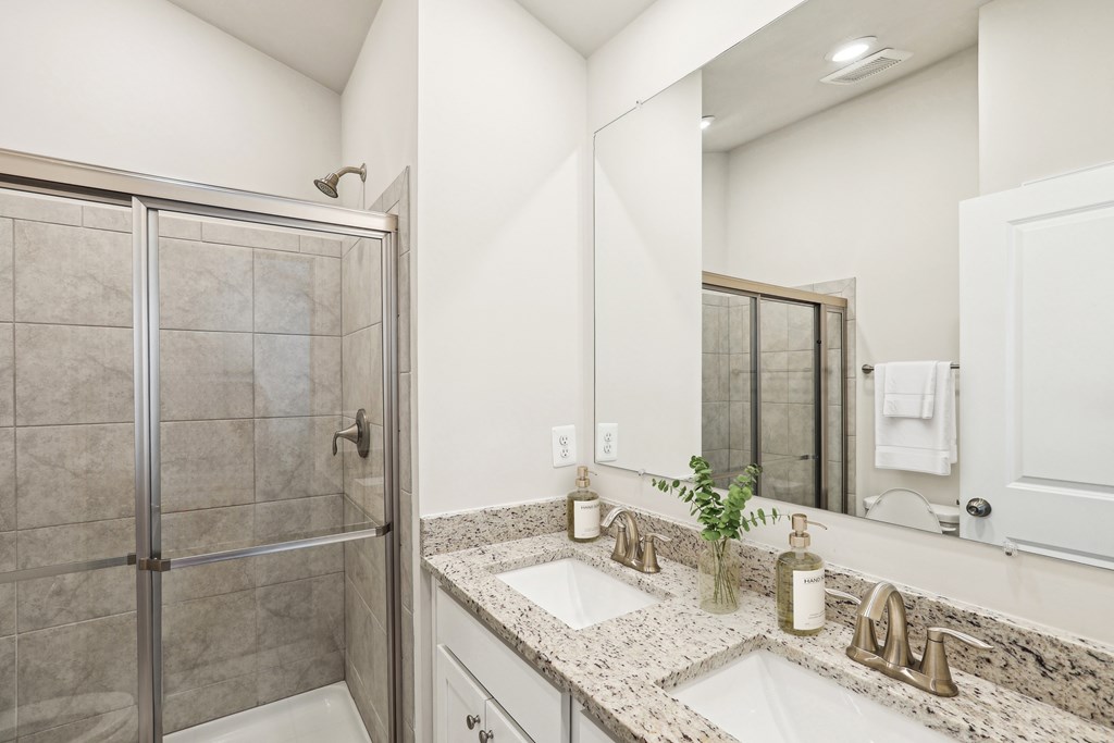 a bathroom with two sinks and a shower a bathroom with two sinks and a shower at Refinery Row, Baltimore, Maryland, 21224