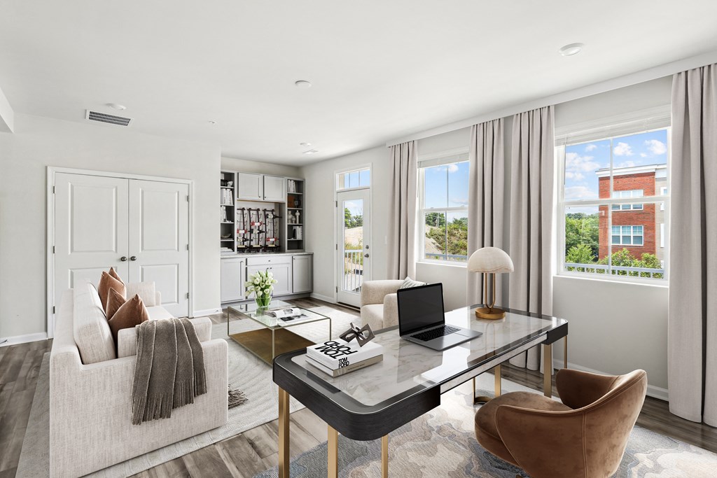 a living room with a couch and chairs and a table