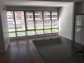 A room with a large window overlooking a building.