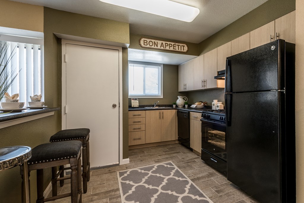 a kitchen with black appliances and a black refrigerator at Meadows at Capitol Heights, Capitol Heights