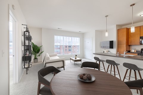 A modern kitchen with a dining table and chairs.