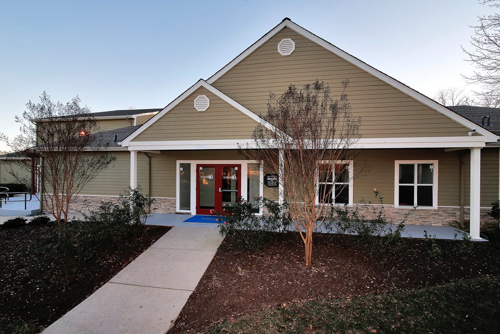 a house with a red door and a sidewalk in front of it at Villages at Morgan Metro, Landover, MD 20785