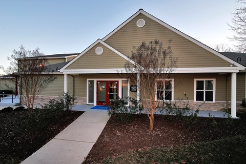 a house with a red door and a sidewalk in front of it at Villages at Morgan Metro, Landover, MD 20785