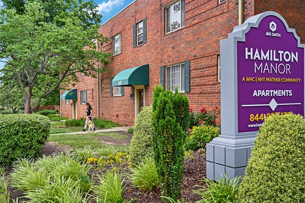 a brick building with a sign apartments at Hamilton Manor Apartments, Maryland