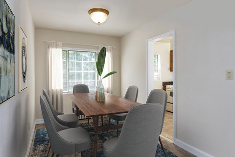a dining room with a wooden table and chairs at Hamilton Manor Apartments, Hyattsville, MD 20782