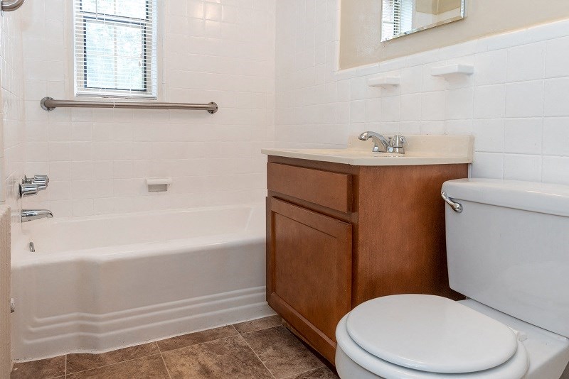 a bathroom with a toilet and a sink and a bath tub at Hamilton Manor Apartments, Hyattsville, MD