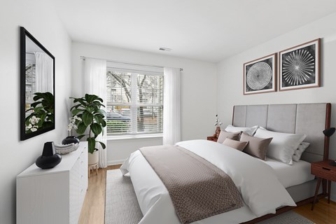 A bedroom with a large bed and a mirror on the wall.