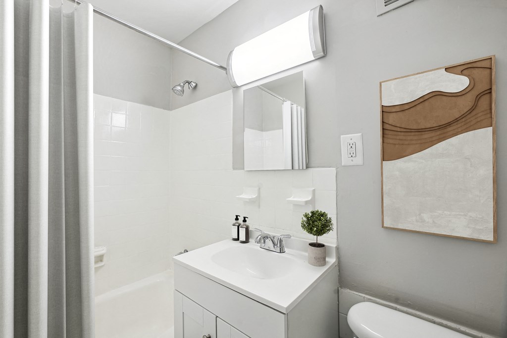 a small bathroom with a sink and a shower at Laurel Pines, Laurel, MD