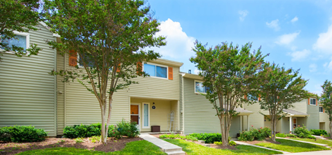 a yellow house with trees in front of it at Villages at Morgan Metro, Landover, MD 20785