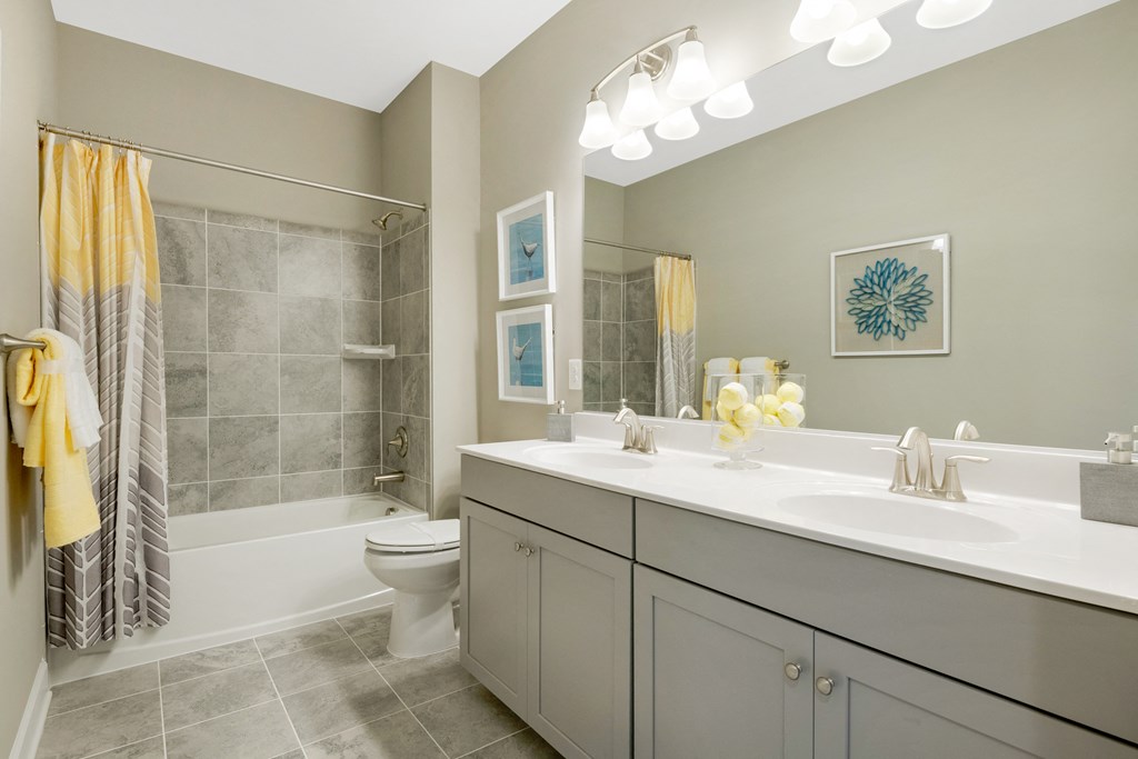 a bathroom with a sink and a shower and a toilet