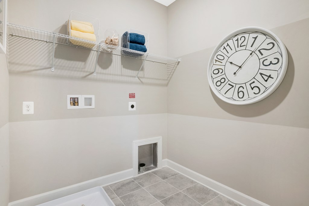 a room with a large clock on the wall and a closet