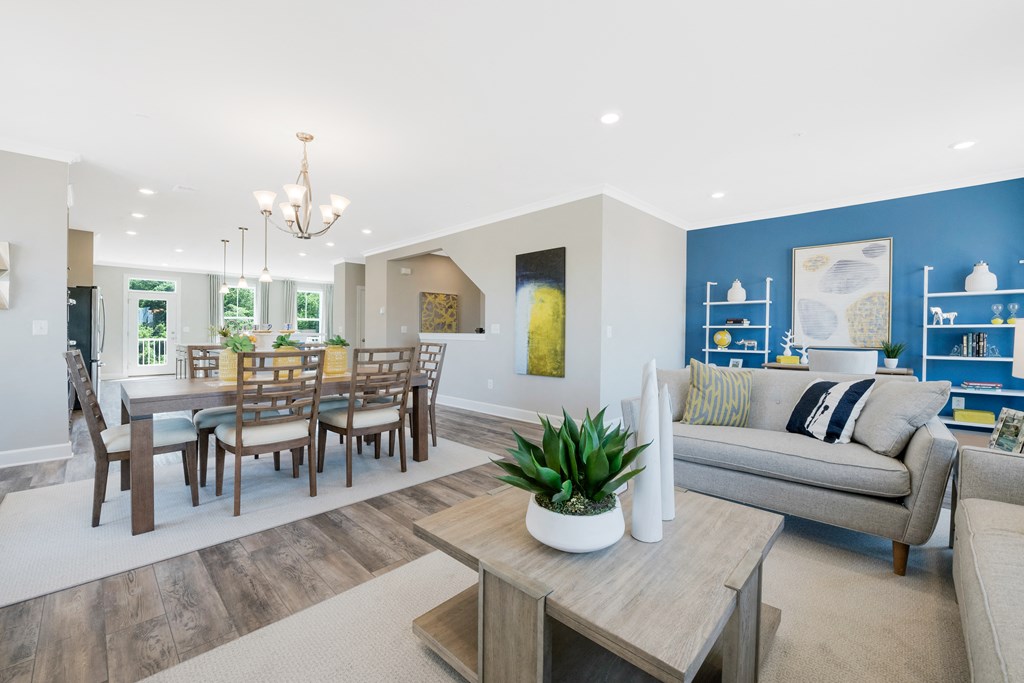 a living room and dining room with blue walls and a table