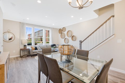 a dining room with a glass table and chairs