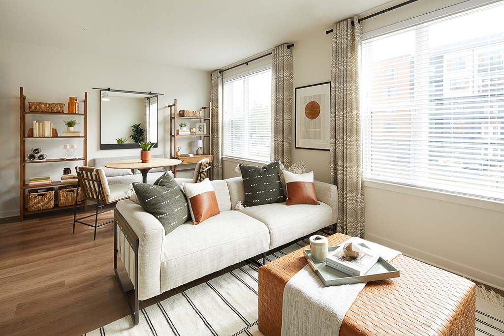 A living room with a white sofa and a coffee table.