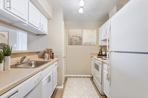 a kitchen with white appliances and white cabinets