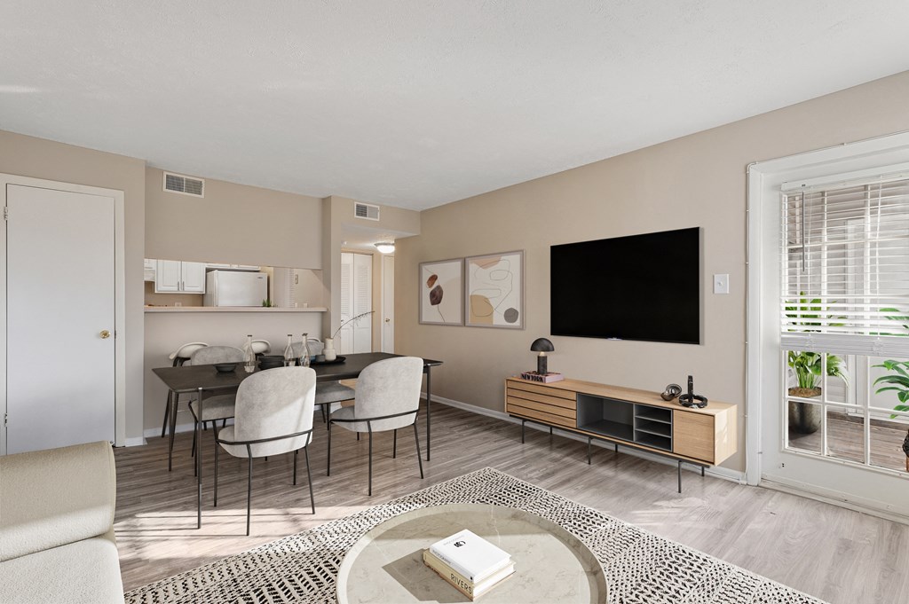 a living room and dining room with a table and chairs at Madison at Eden Brook, Columbia, 21046