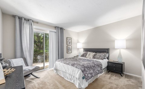 A bedroom with a large bed and a window with curtains at Madison at Eden Brook, 21046